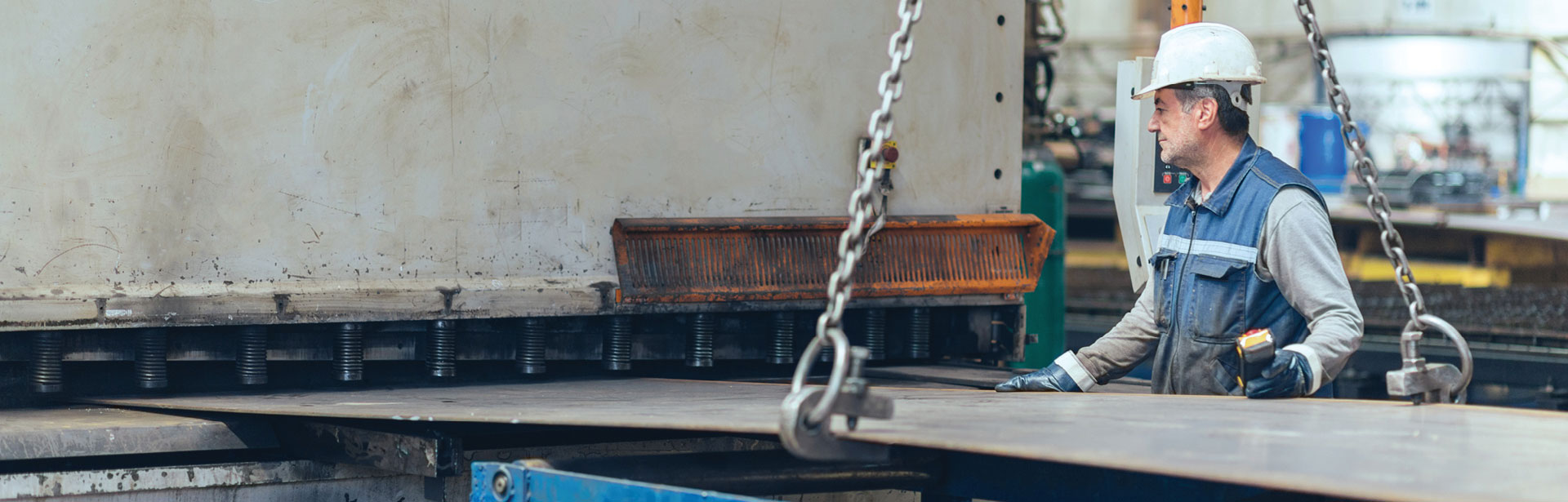 industrial worker moving a large piece of metal