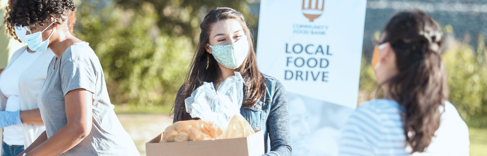 Happy patrons at a local food drive carrying bread