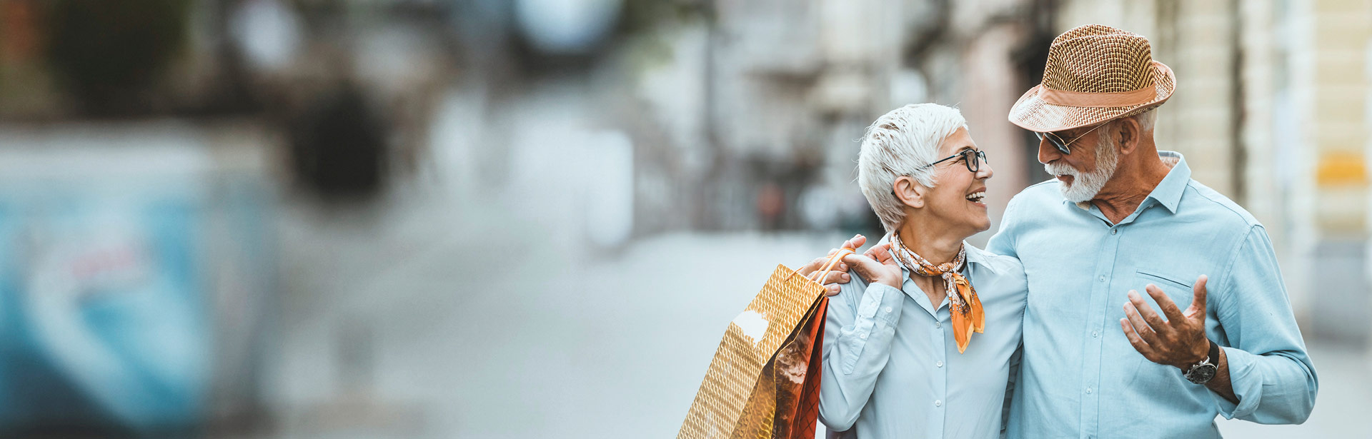 Older couple happily walking down the street