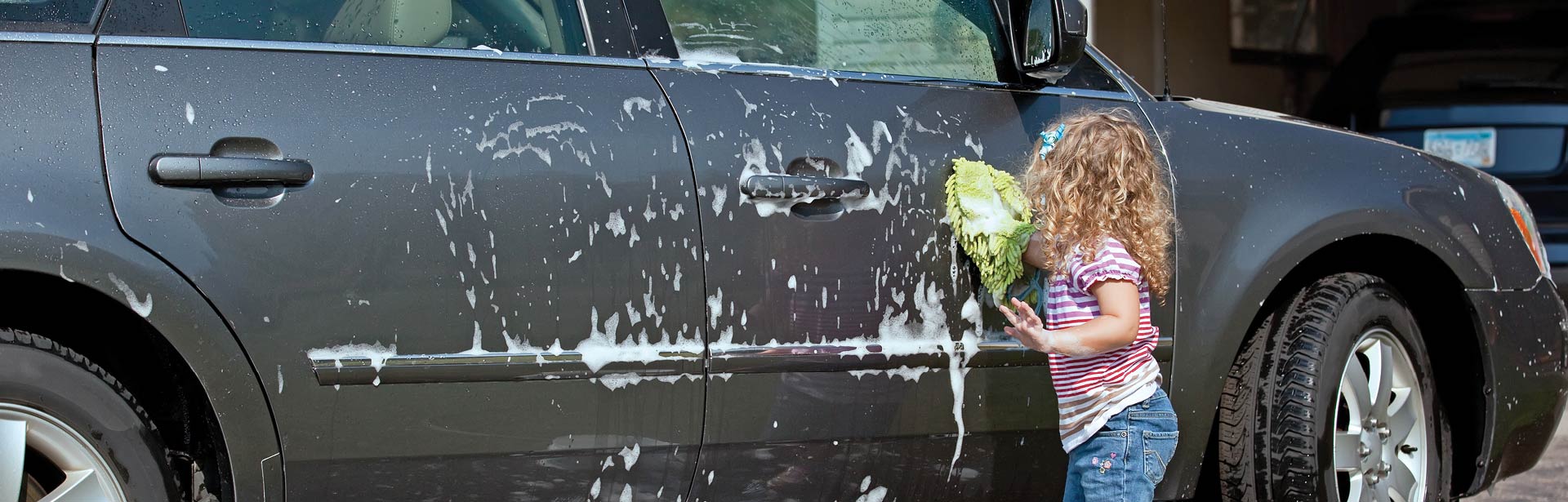 Kid washing a car